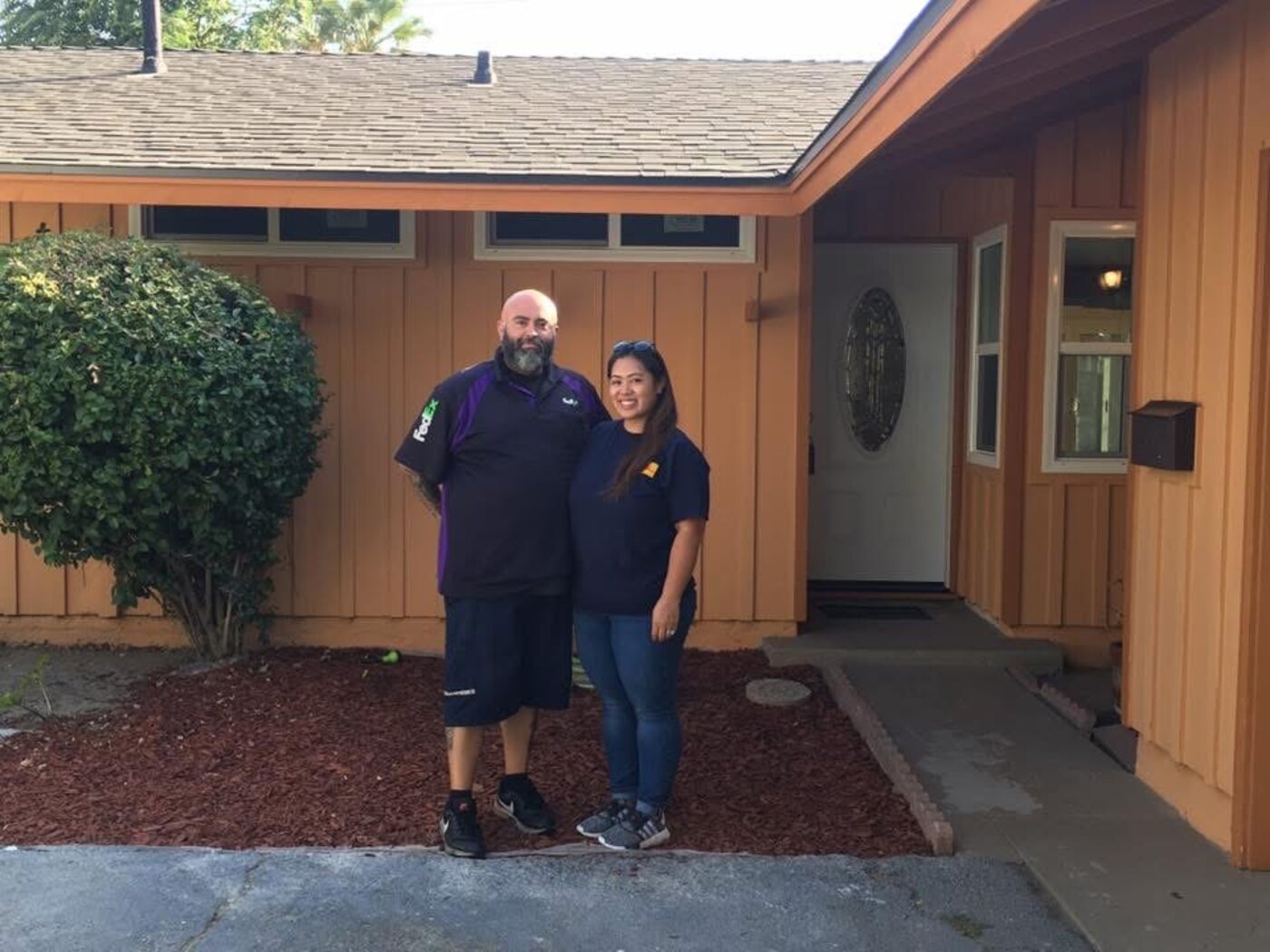 The Sandovals standing in front of their new La Puente home